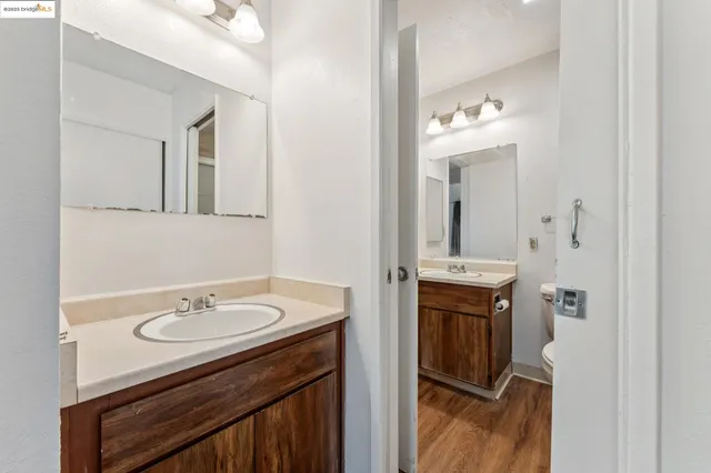 a bathroom with a sink vanity granite and a mirror