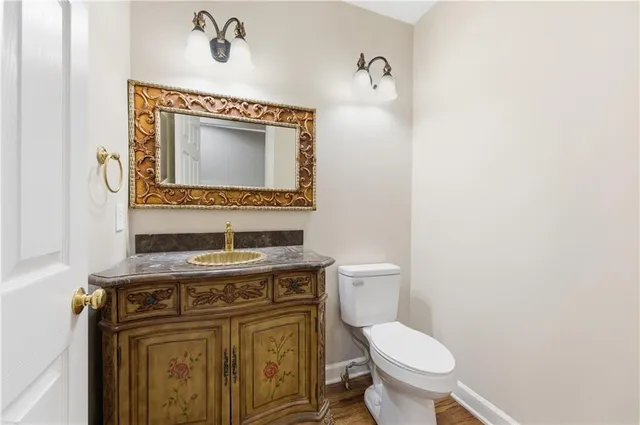 a view of a livingroom with wooden floor and staircase