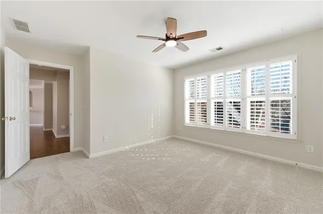 a view of a room with a ceiling fan and a chandelier fan
