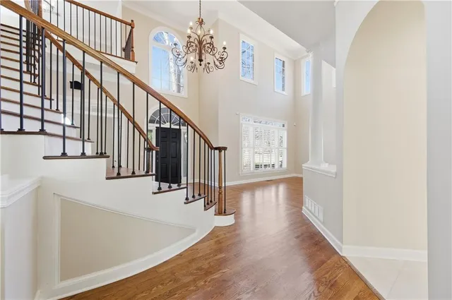 a view of entryway and hall with wooden floor