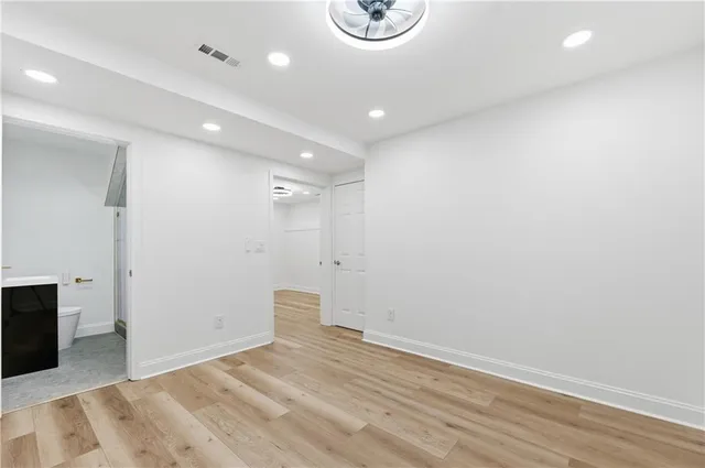 a bathroom with a tub sink toilet and a mirror