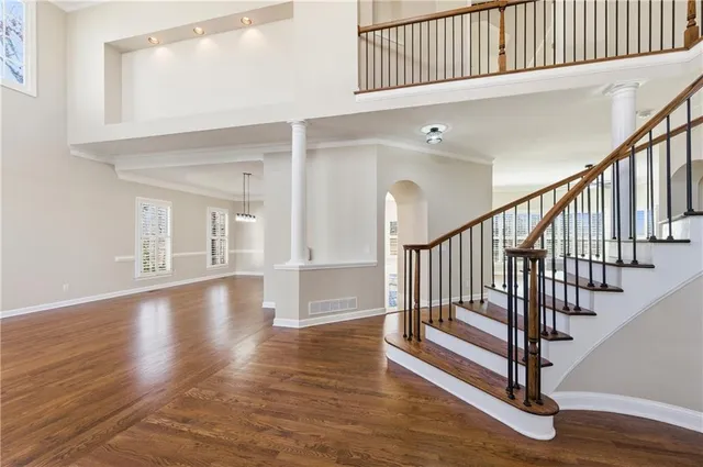 a view of entryway and hall with wooden floor
