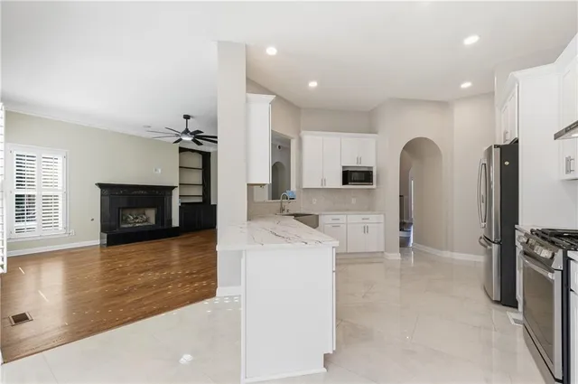 a view of an empty room with a fireplace and a window