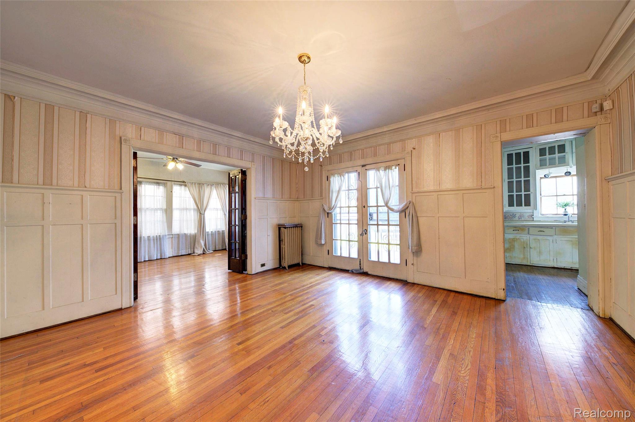 121 Longfellow Street Detroit, MI 48202 - Photo 24 of 87 Unfurnished dining area with a decorative wall, plenty of natural light, wainscoting, light wood finished floors, and ornamental molding
