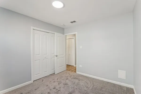 a view of an empty room with closet