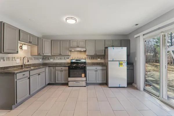 a kitchen with granite countertop appliances and cabinets