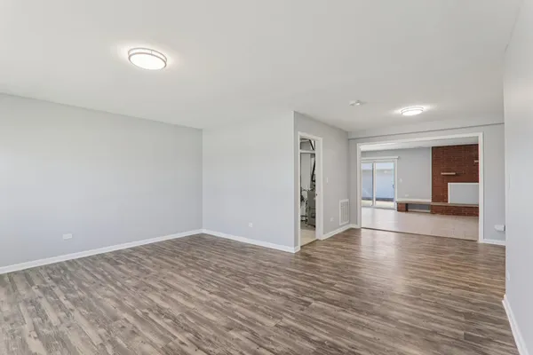 a view of a room with wooden floor and cabinet