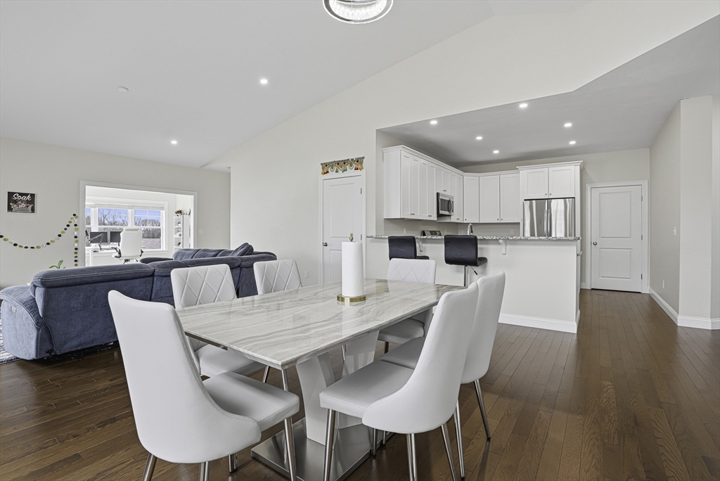 52 Logans Run, Unit 52 Millbury, MA 01527 - Photo 11 of 41 a view of a dining room with furniture and wooden floor