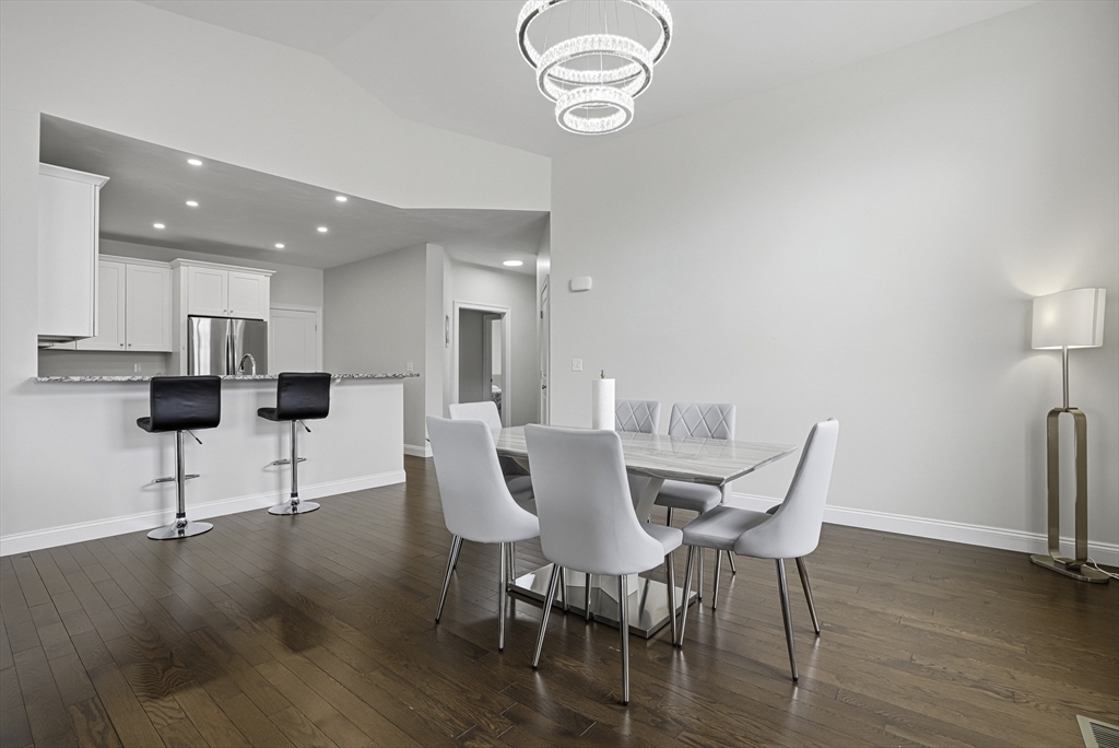 52 Logans Run, Unit 52 Millbury, MA 01527 - Photo 12 of 41 a view of a dining room with furniture and wooden floor