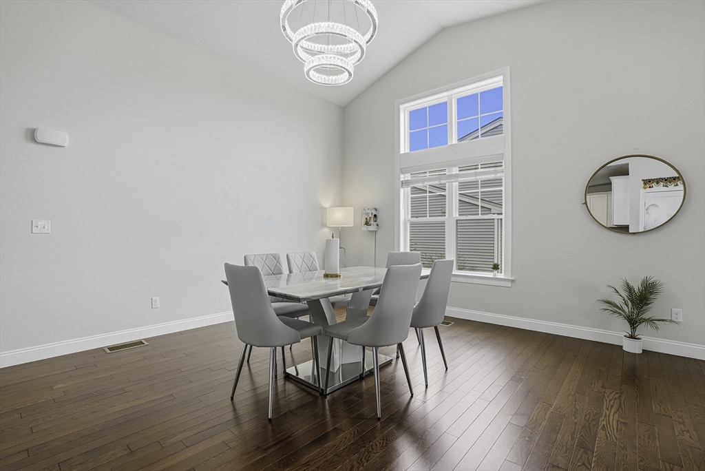 52 Logans Run, Unit 52 Millbury, MA 01527 - Photo 13 of 41 a view of a dining room with furniture window and wooden floor