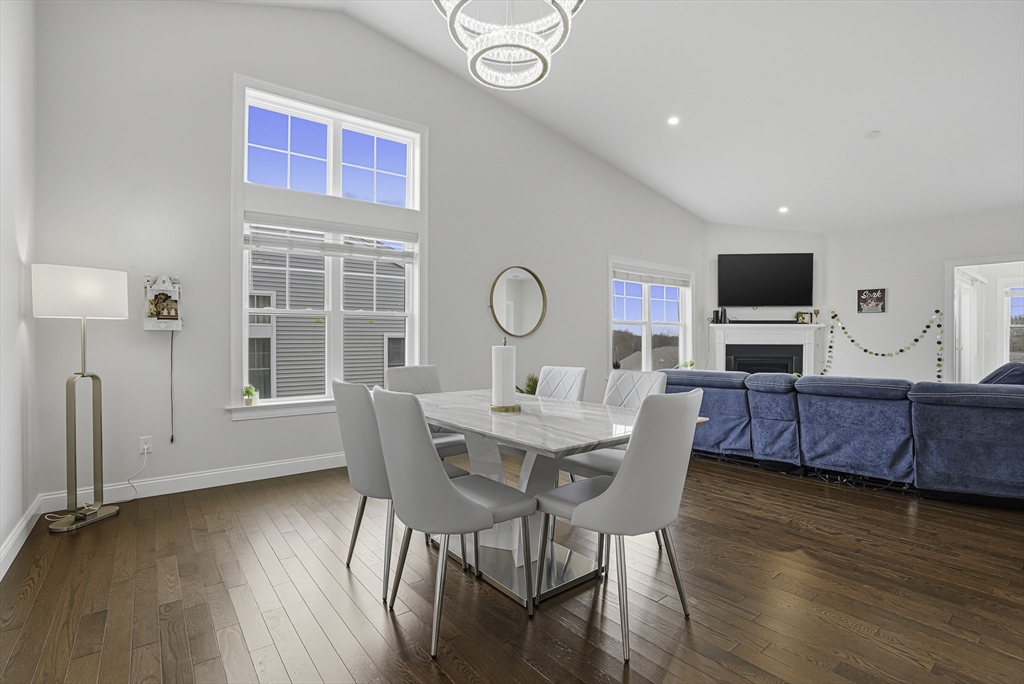 52 Logans Run, Unit 52 Millbury, MA 01527 - Photo 14 of 41 a view of a dining room with furniture window and wooden floor