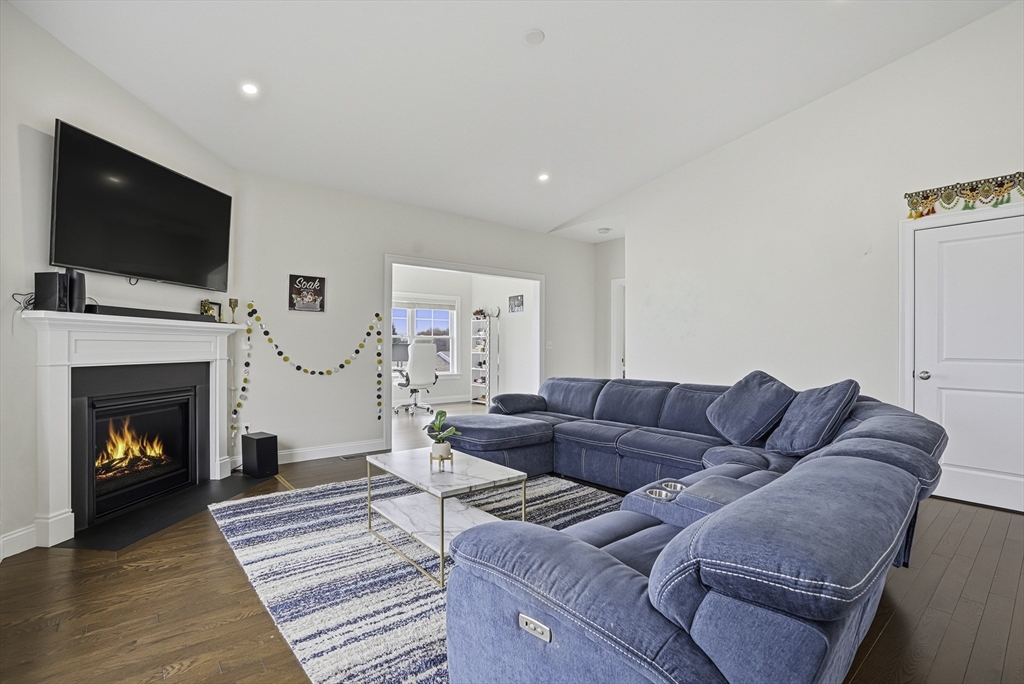 52 Logans Run, Unit 52 Millbury, MA 01527 - Photo 15 of 41 a living room with furniture fireplace and flat screen tv