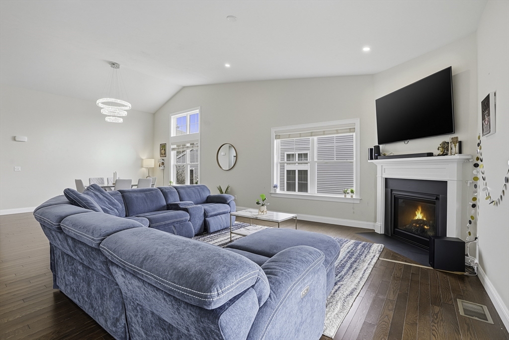 52 Logans Run, Unit 52 Millbury, MA 01527 - Photo 18 of 41 a living room with furniture fireplace and flat screen tv
