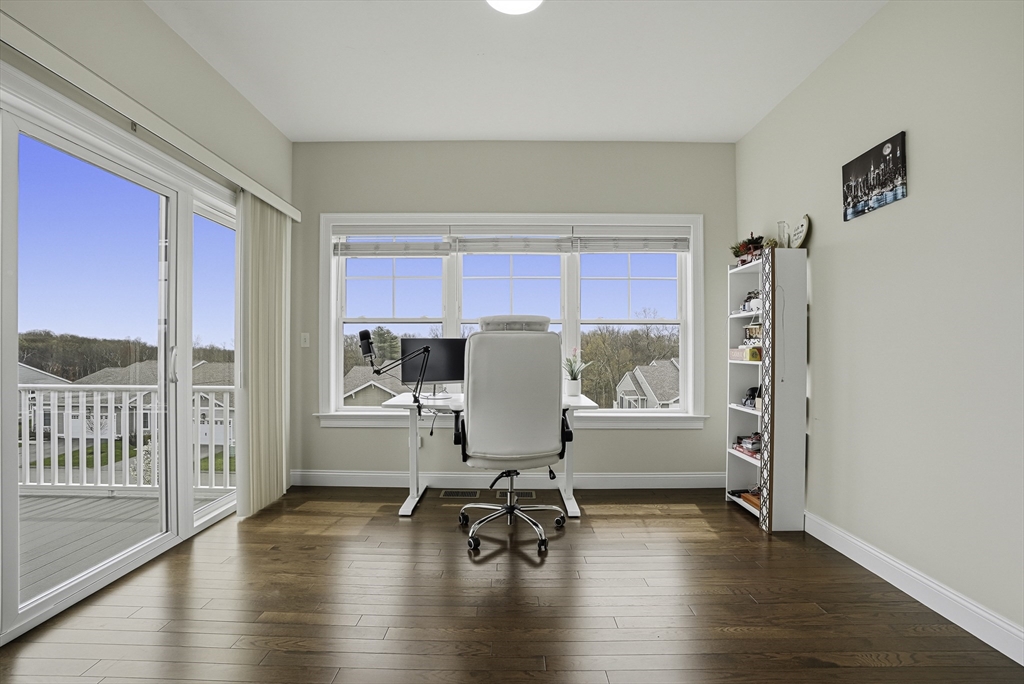 52 Logans Run, Unit 52 Millbury, MA 01527 - Photo 21 of 41 a workspace with furniture wooden floor and a window