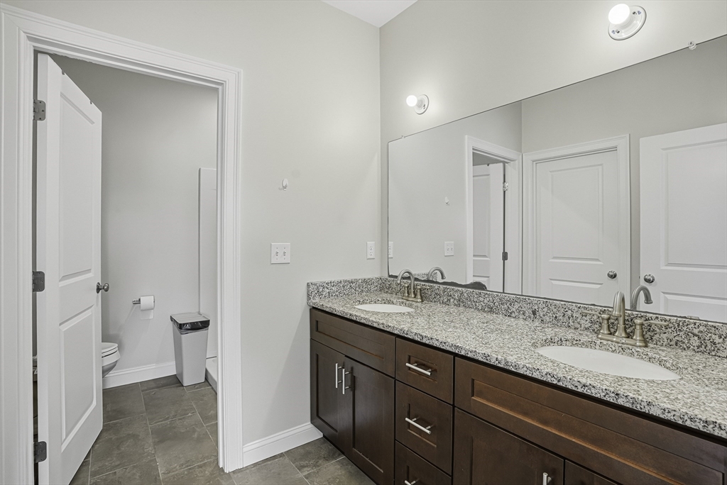 52 Logans Run, Unit 52 Millbury, MA 01527 - Photo 27 of 41 a bathroom with a granite countertop sink and a mirror