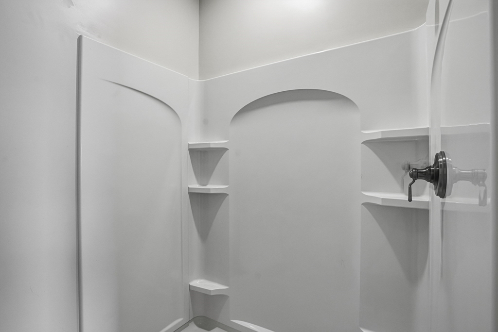 52 Logans Run, Unit 52 Millbury, MA 01527 - Photo 28 of 41 a bathroom with a shower a toilet and sink