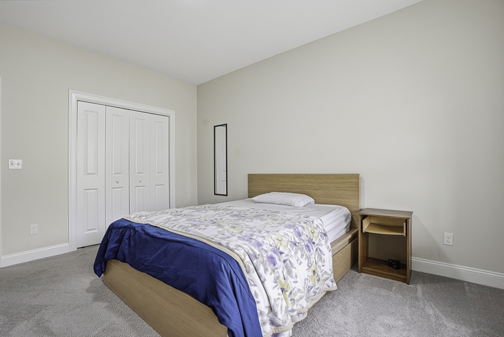 52 Logans Run, Unit 52 Millbury, MA 01527 - Photo 29 of 41 a bedroom with a bed and a closet