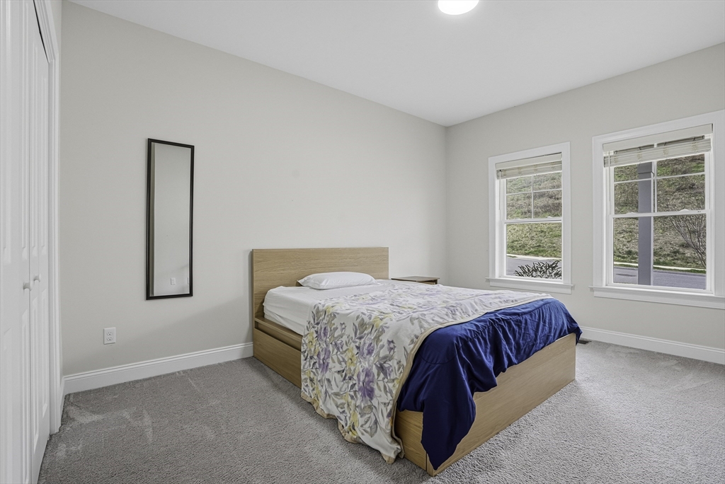 52 Logans Run, Unit 52 Millbury, MA 01527 - Photo 30 of 41 a bedroom with a bed and a window