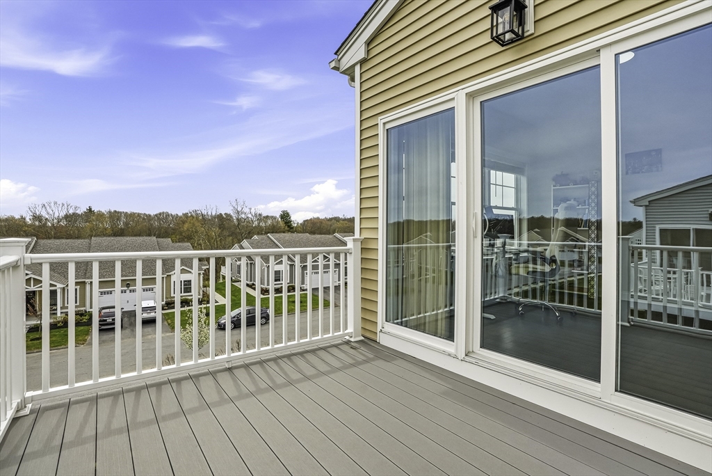52 Logans Run, Unit 52 Millbury, MA 01527 - Photo 38 of 41 a view of a balcony with wooden floor and fence and city view