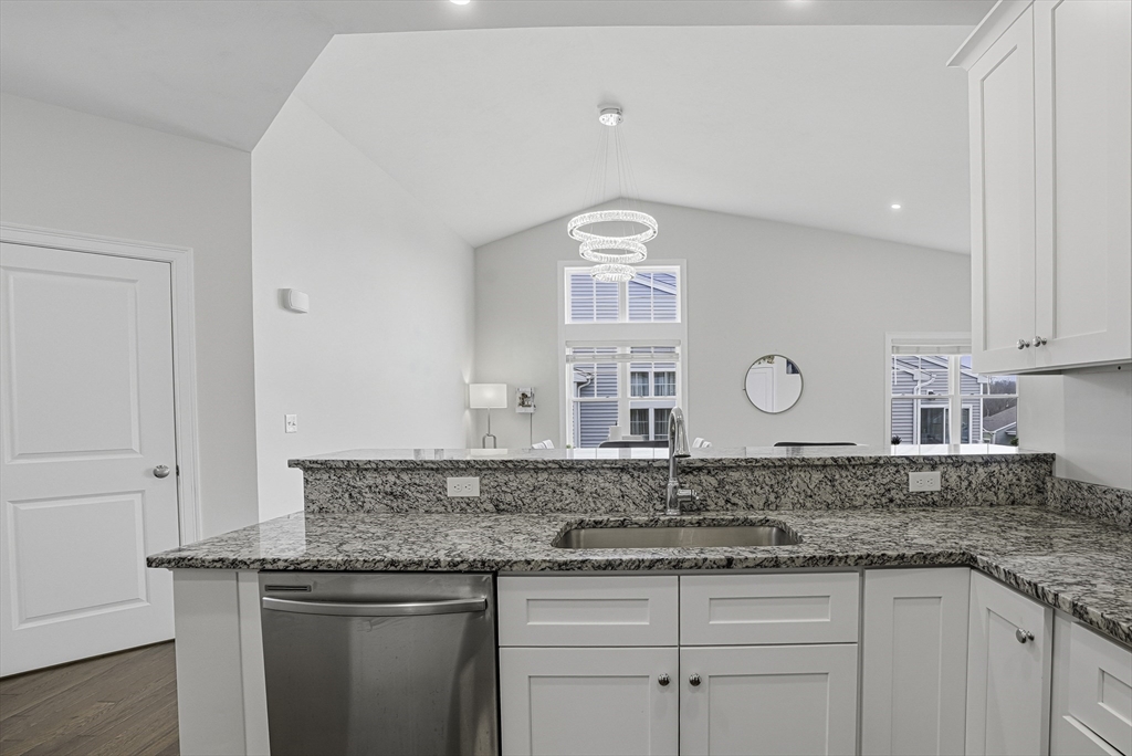 52 Logans Run, Unit 52 Millbury, MA 01527 - Photo 8 of 41 a kitchen with granite countertop a sink and cabinets