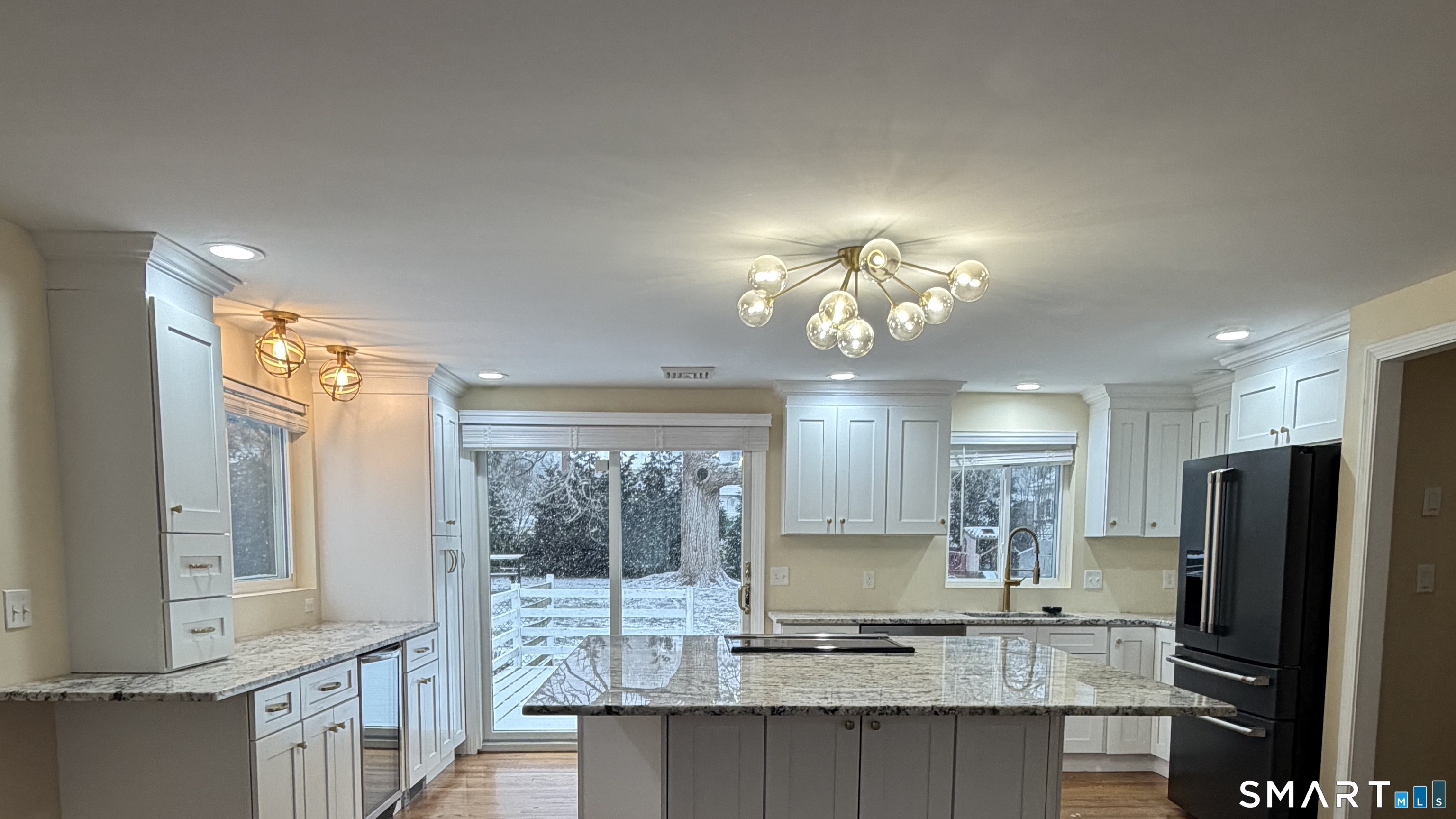 19 Evergreen Drive Clinton, CT 06413 - Photo 21 of 30 a view of kitchen with granite countertop cabinets and refrigerator