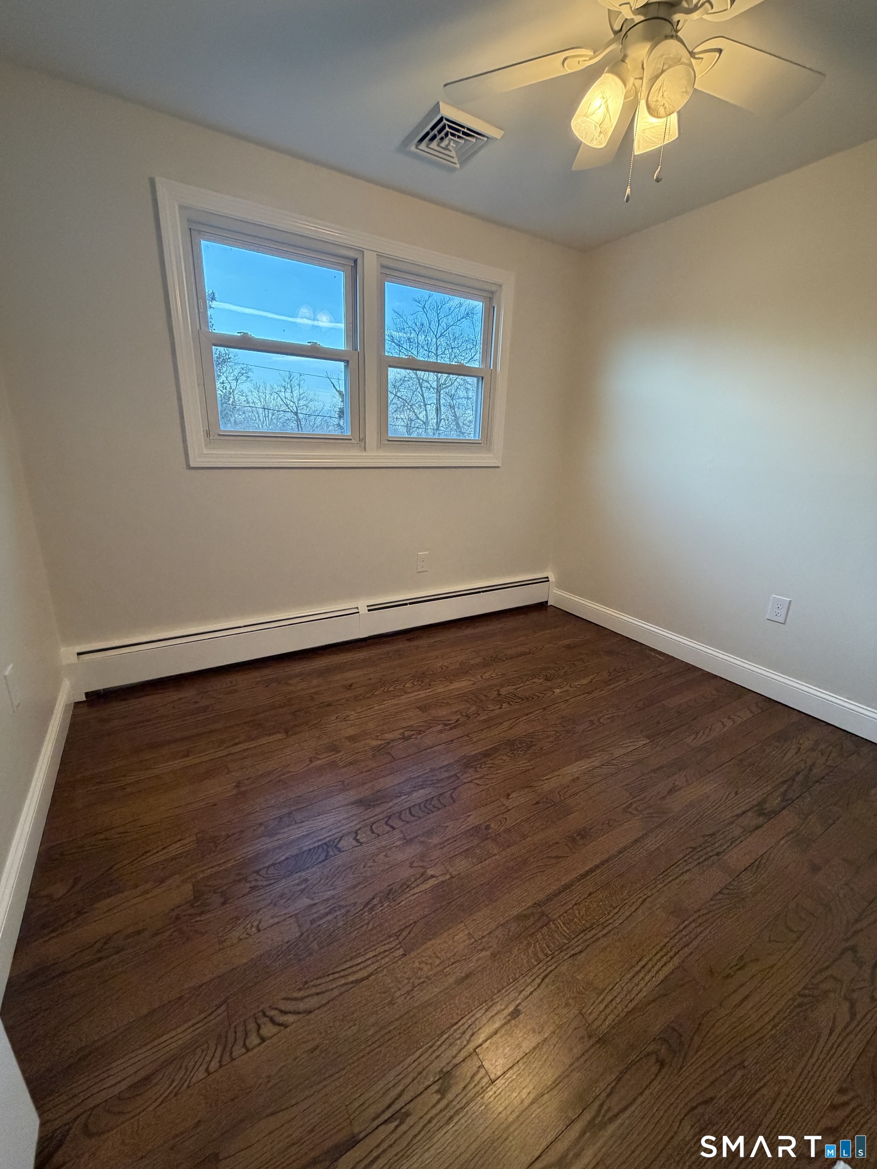19 Evergreen Drive Clinton, CT 06413 - Photo 25 of 30 an empty room with wooden floor and windows