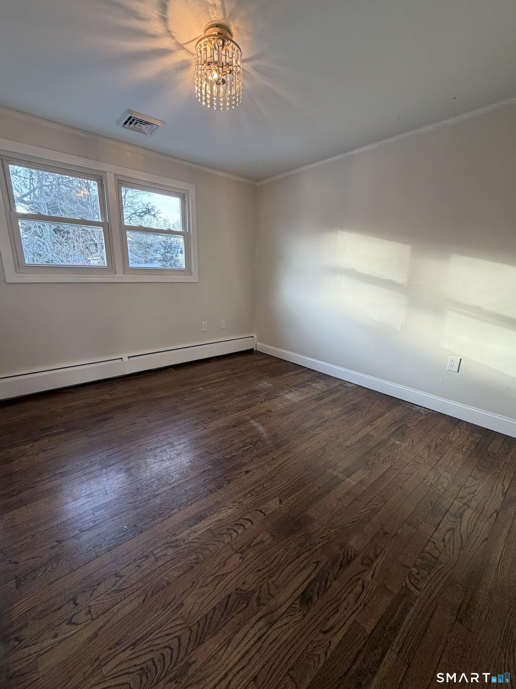 19 Evergreen Drive Clinton, CT 06413 - Photo 26 of 30 a view of an empty room with wooden floor and a window