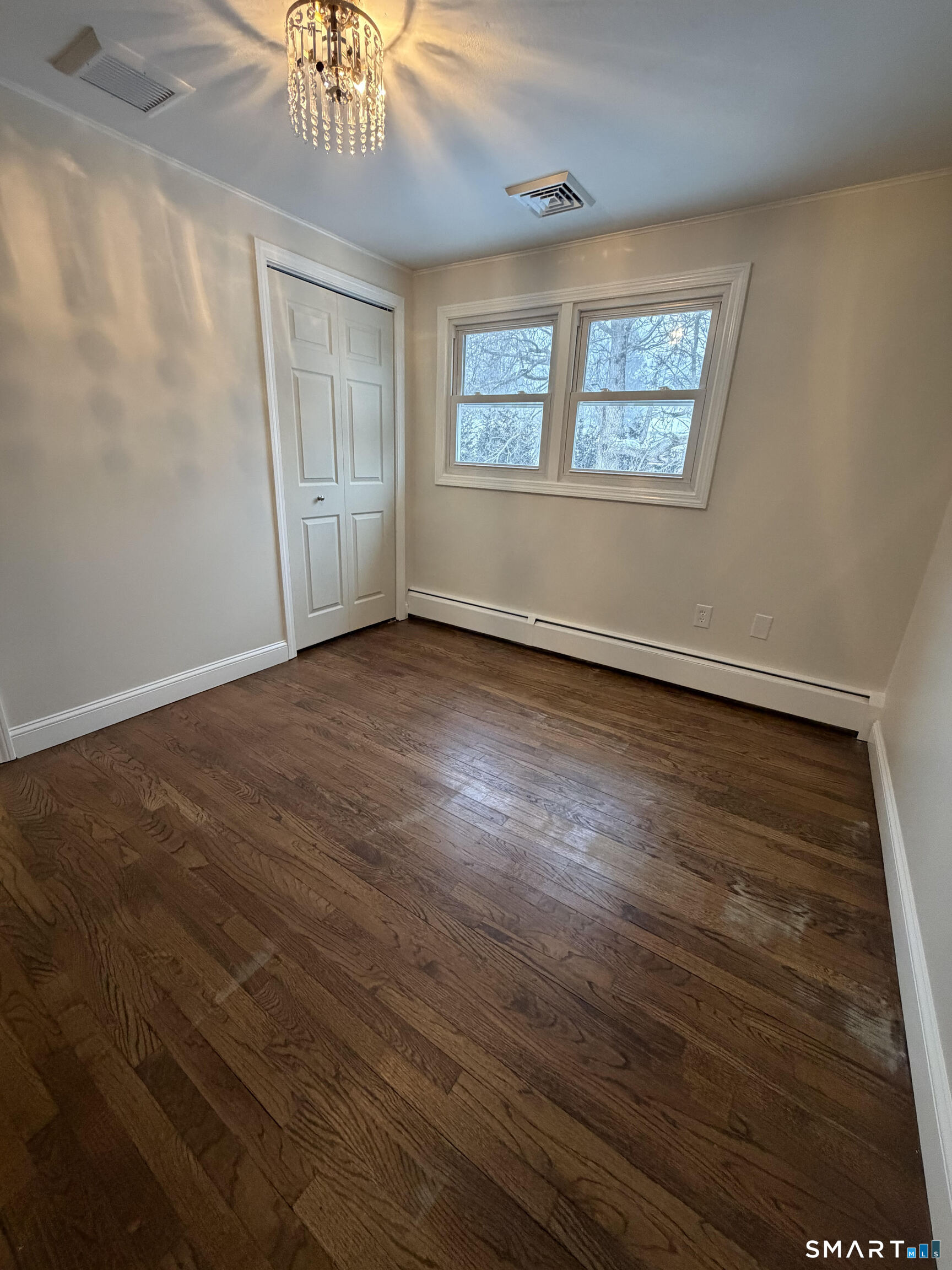 19 Evergreen Drive Clinton, CT 06413 - Photo 27 of 30 a view of an empty room with wooden floor and a window