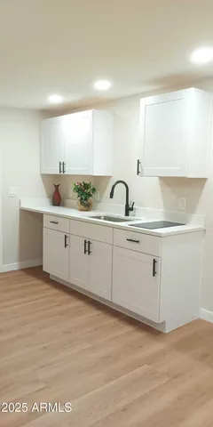 a kitchen with a sink cabinets and appliances
