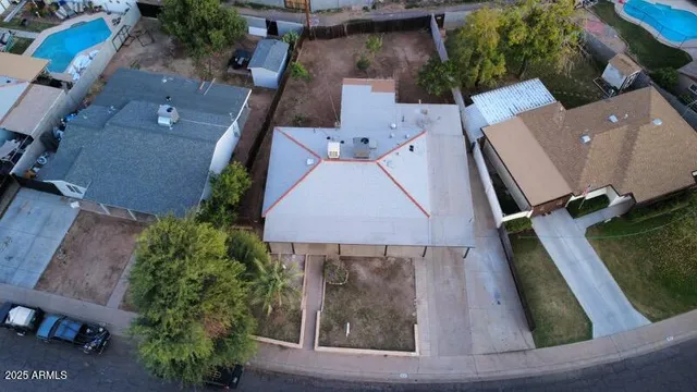 an aerial view of residential houses with outdoor space