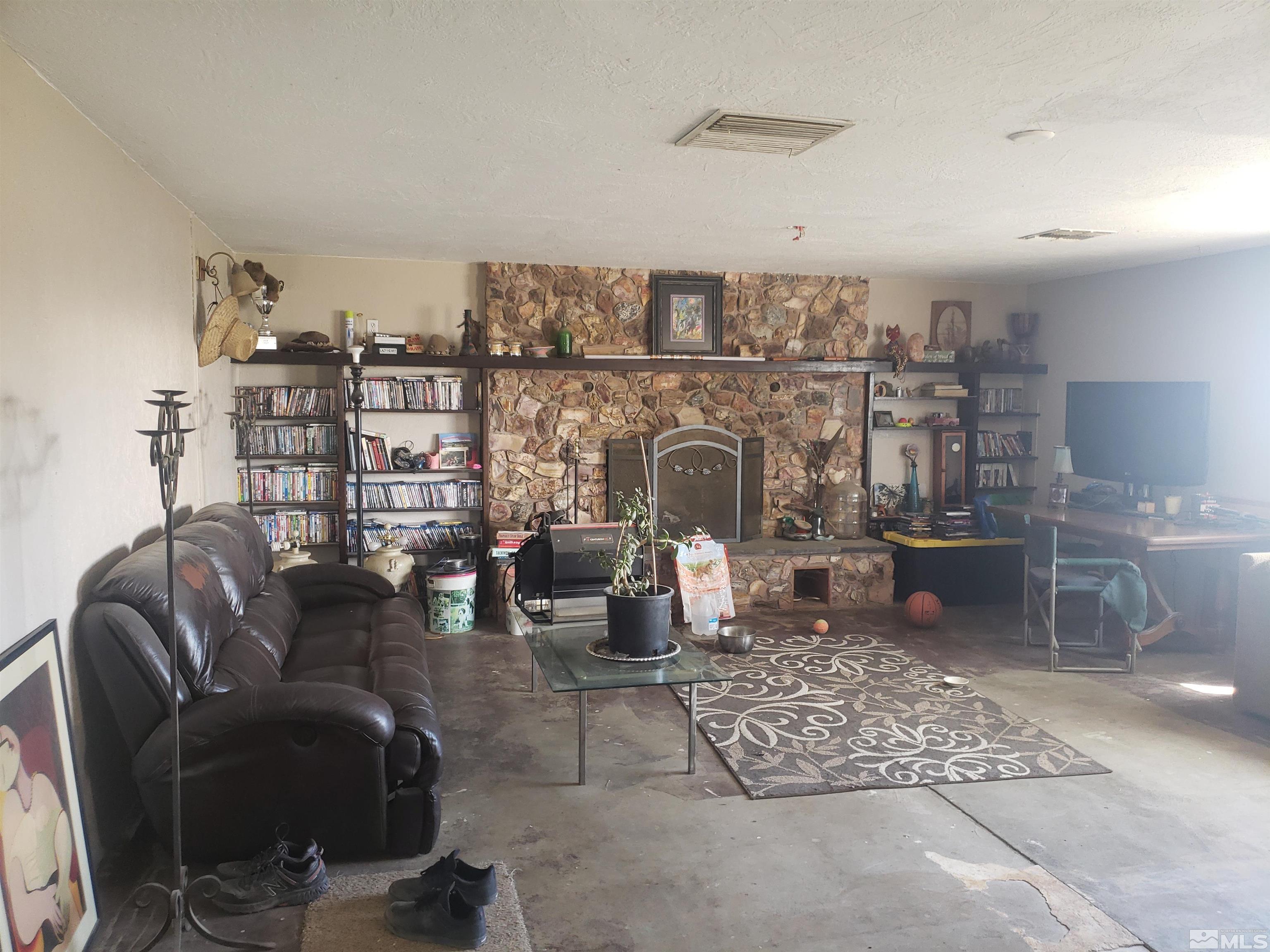 4044 Schurz Highway Fallon, NV 89406 - Photo 5 of 29 a living room with furniture a rug and a fireplace