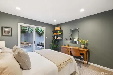 a bedroom with a bed window and table