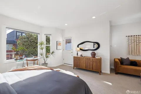 a bedroom with a bed and a chair