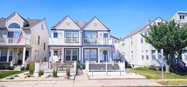 a front view of a residential apartment building with a yard