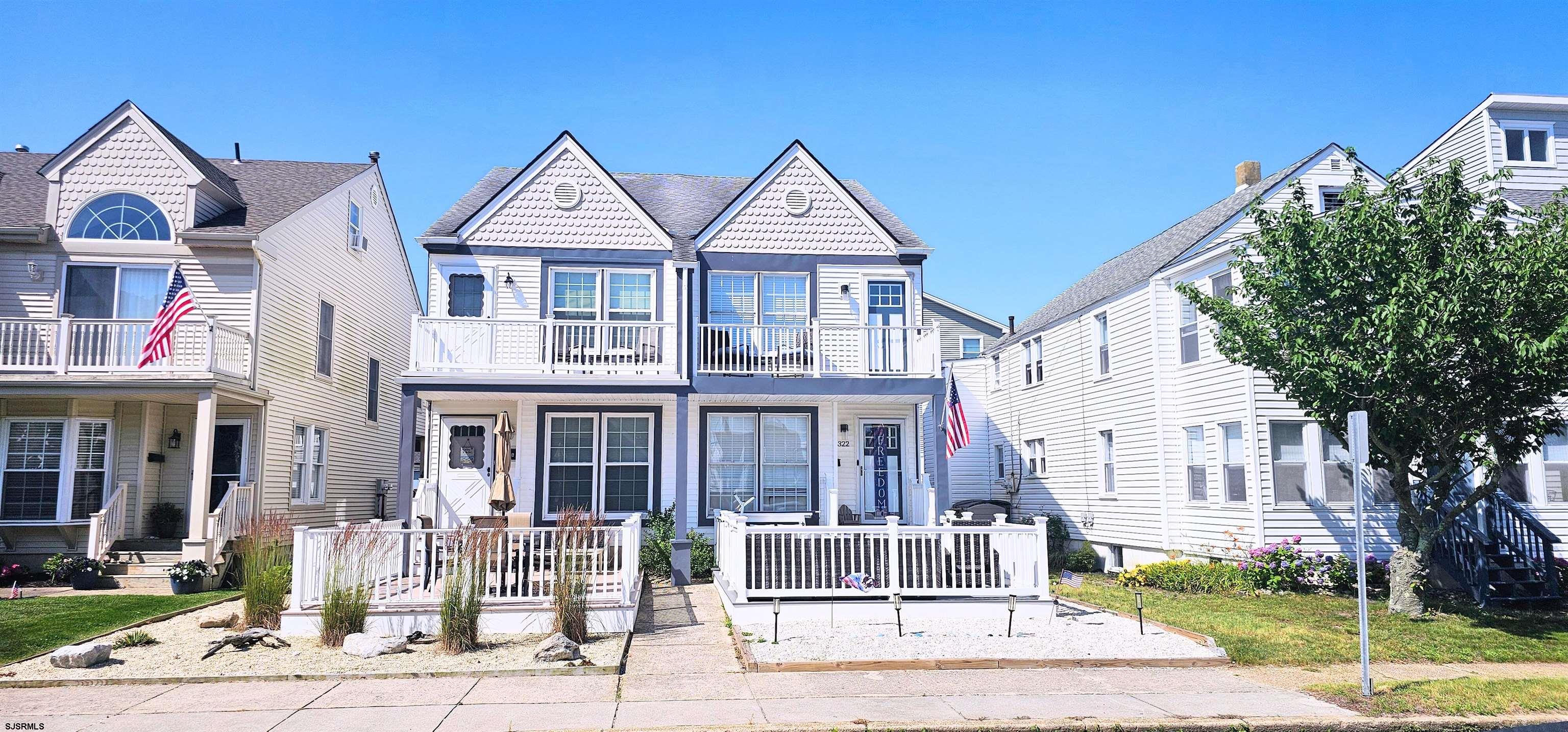 a front view of a residential apartment building with a yard