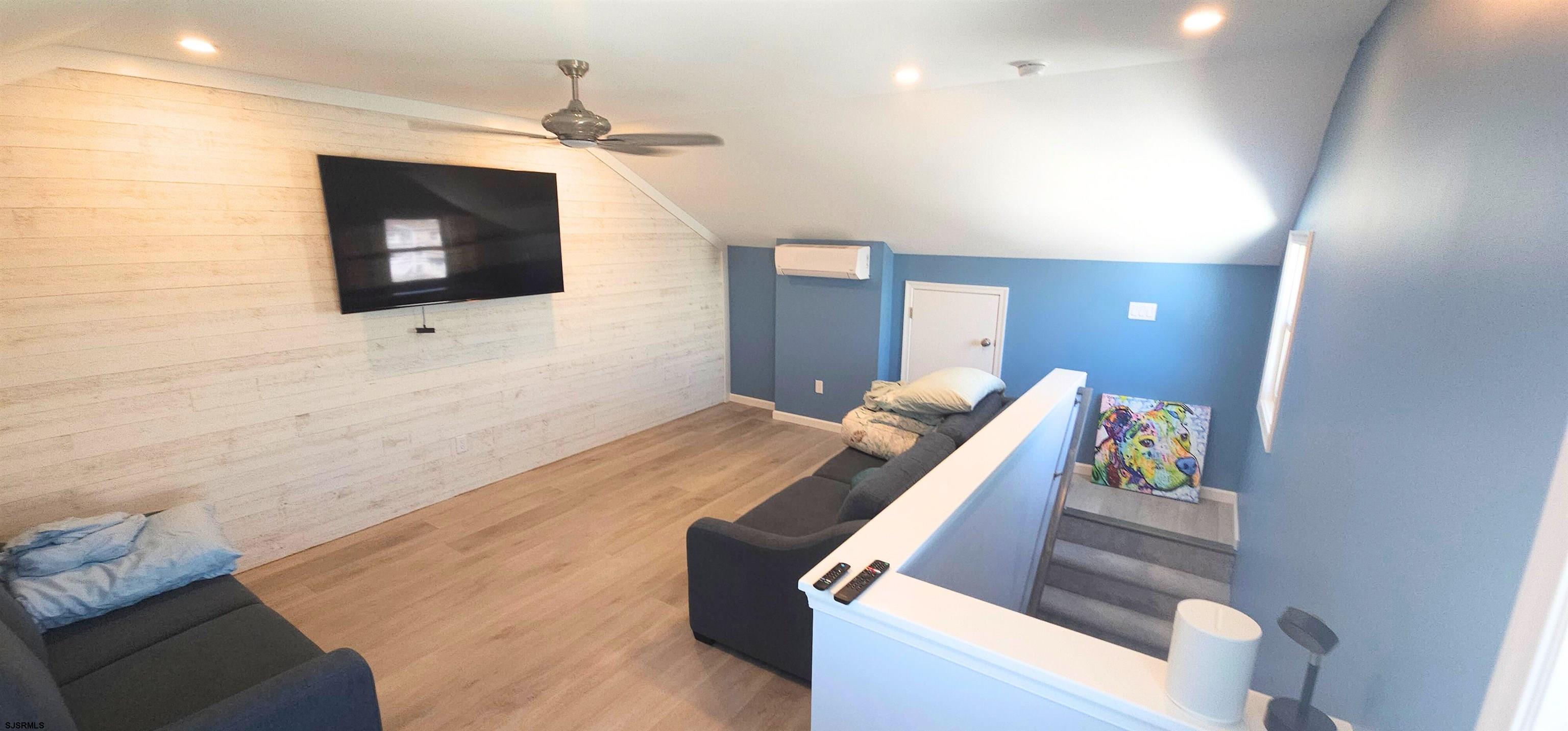 322 38th Street South, Unit B Brigantine, NJ 08203 - Photo 11 of 21 a living room with furniture and a flat screen tv