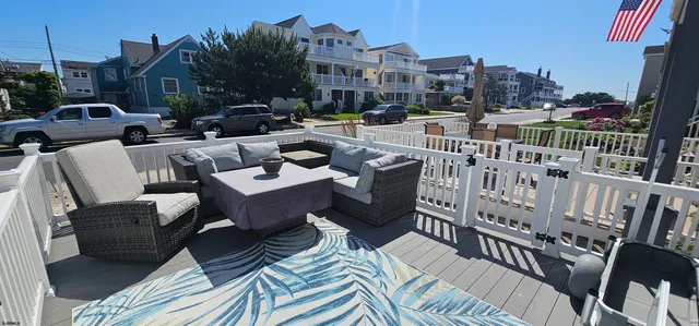 a view of a balcony with two chairs and a deck