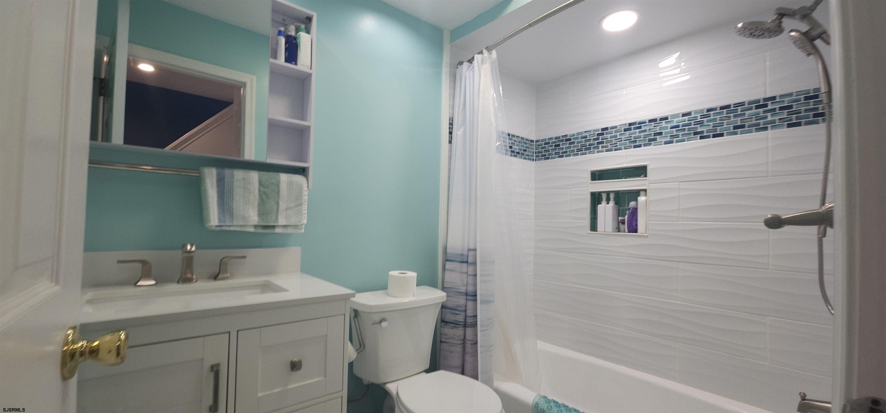 322 38th Street South, Unit B Brigantine, NJ 08203 - Photo 14 of 21 a bathroom with a toilet a sink and mirror