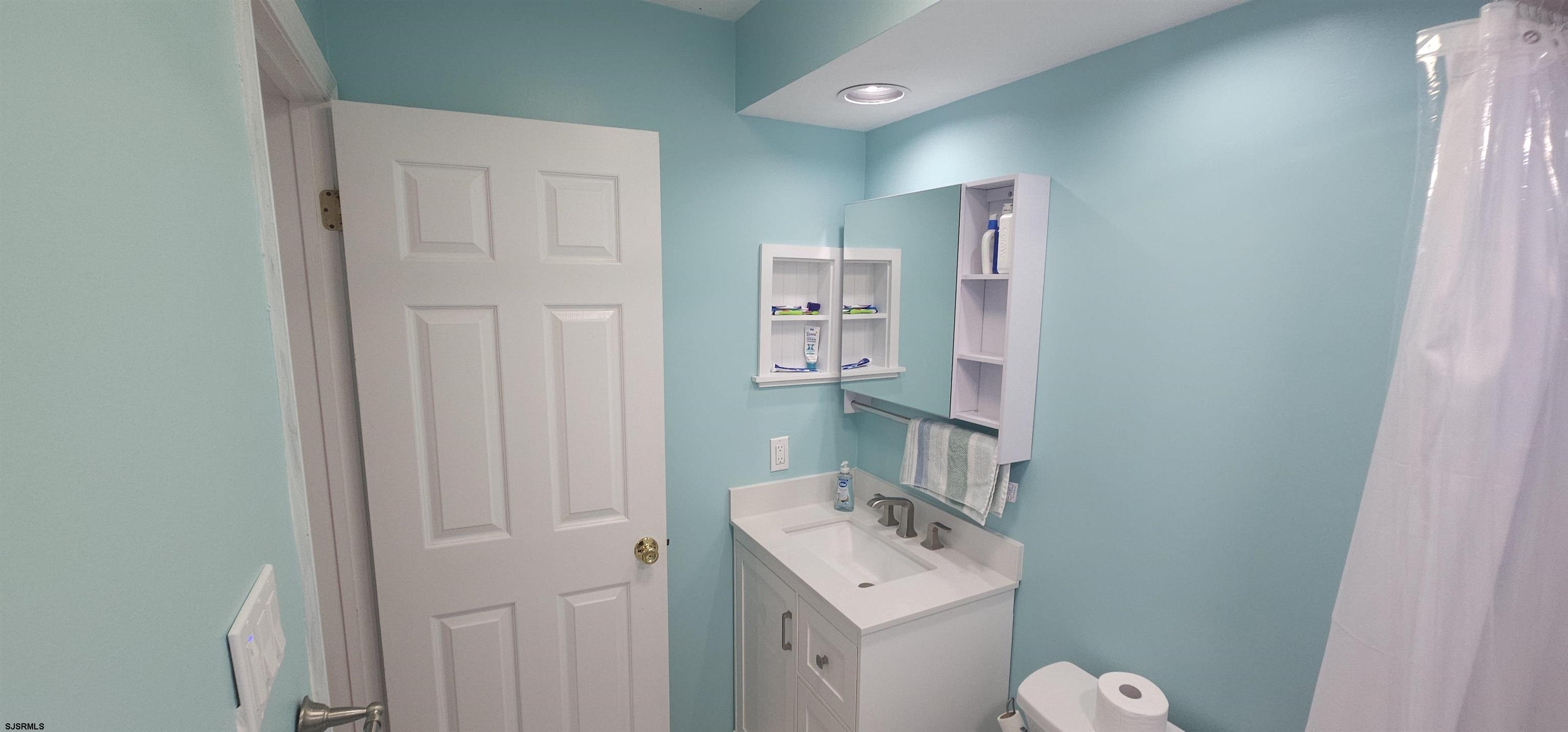 322 38th Street South, Unit B Brigantine, NJ 08203 - Photo 15 of 21 a bathroom with a sink a toilet and shower