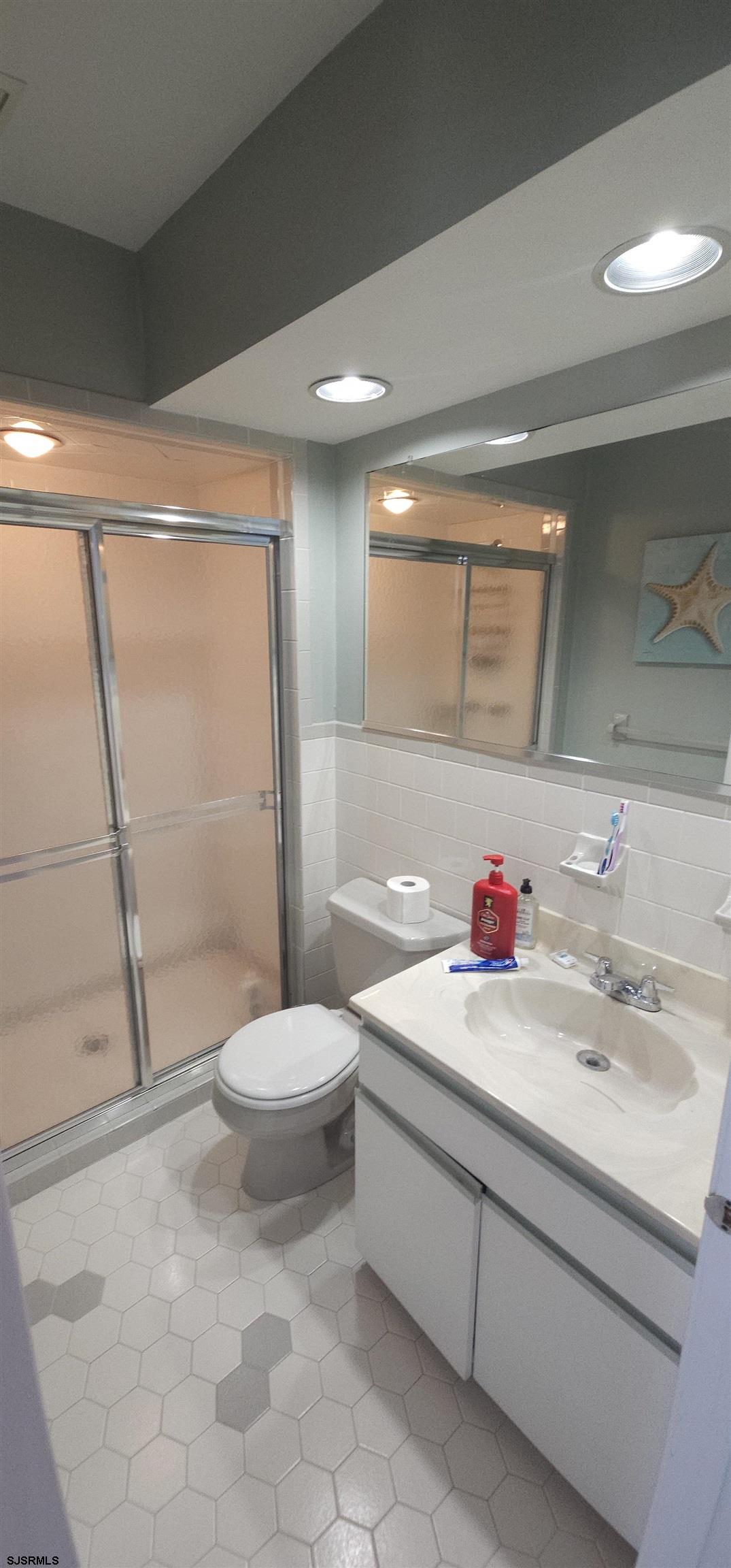 322 38th Street South, Unit B Brigantine, NJ 08203 - Photo 16 of 21 a bathroom with a sink toilet and shower