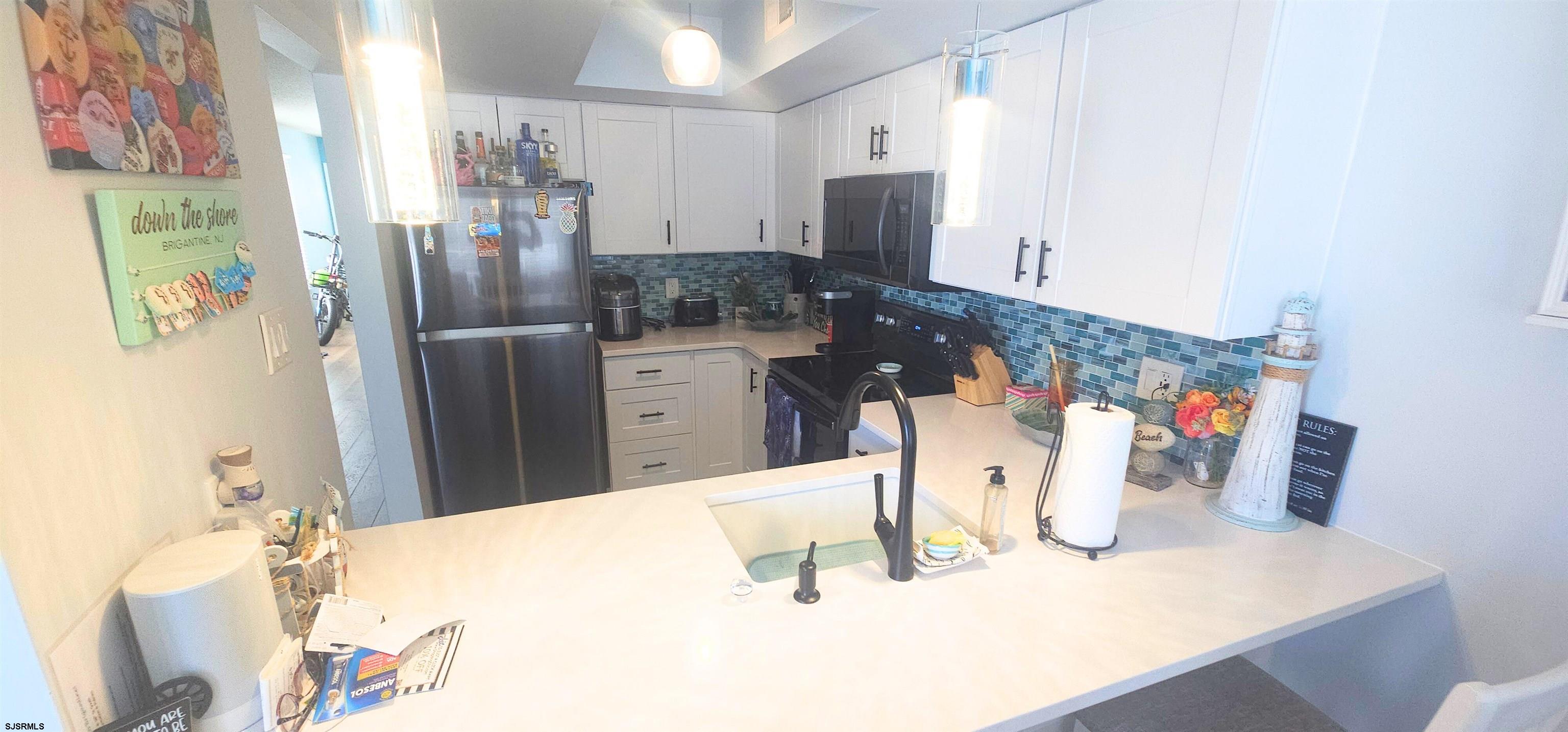 322 38th Street South, Unit B Brigantine, NJ 08203 - Photo 6 of 21 a kitchen with a refrigerator and a stove top oven