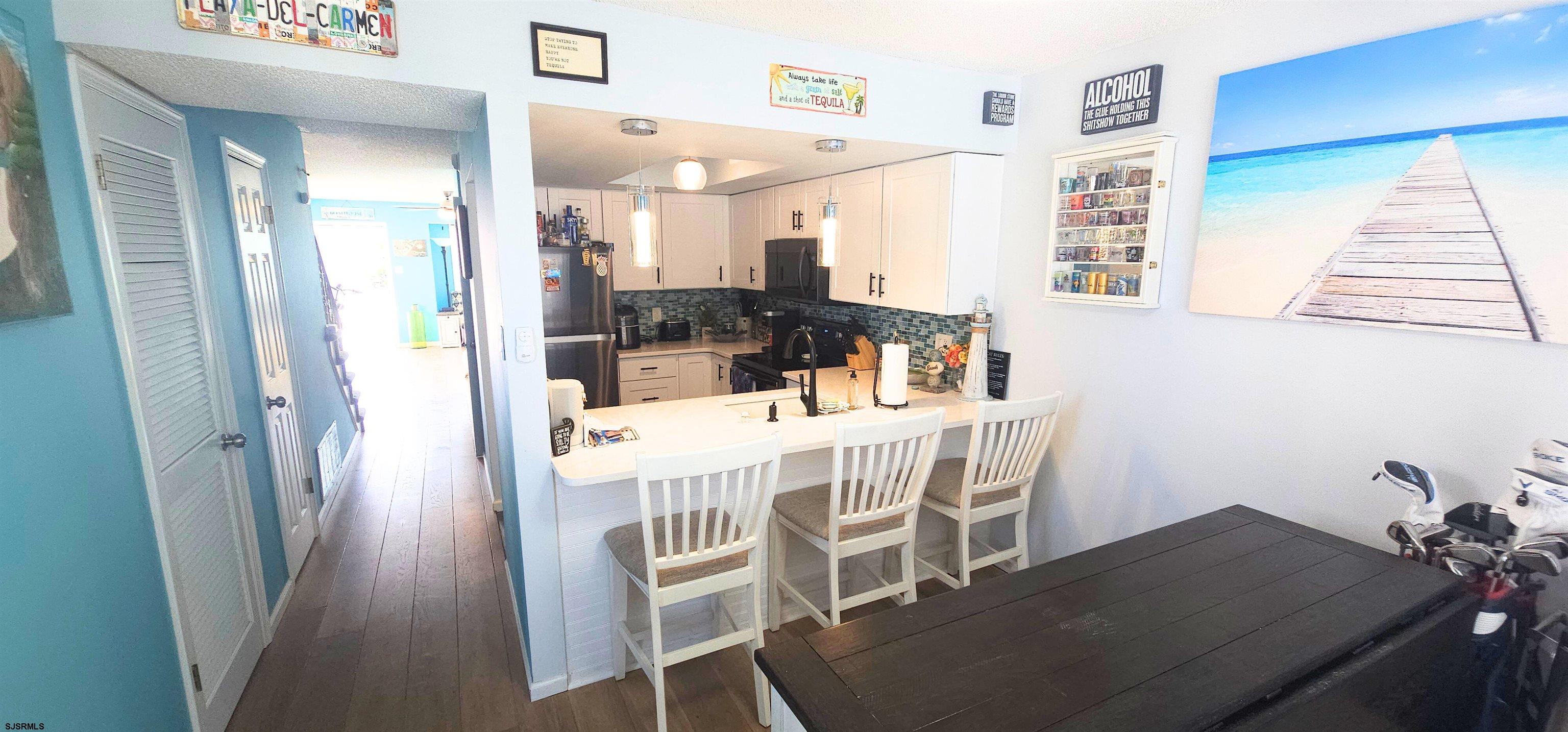 322 38th Street South, Unit B Brigantine, NJ 08203 - Photo 7 of 21 a view of a dining room with furniture and wooden floor