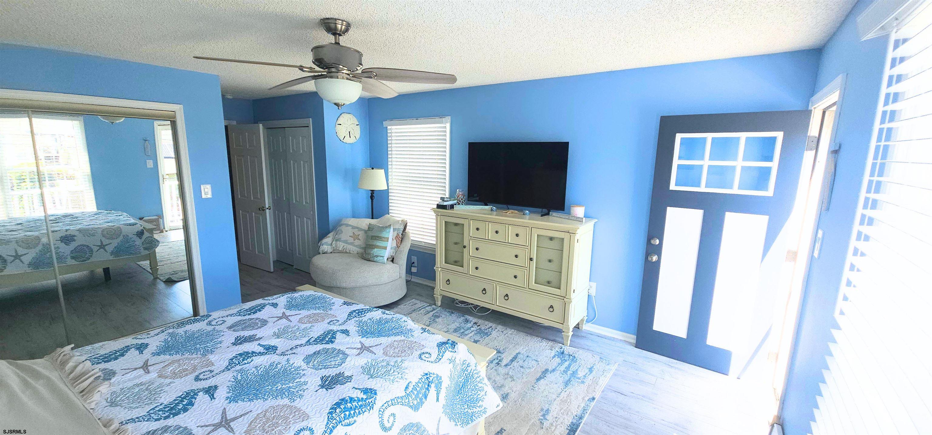 322 38th Street South, Unit B Brigantine, NJ 08203 - Photo 9 of 21 a bedroom with a bed and wooden floor