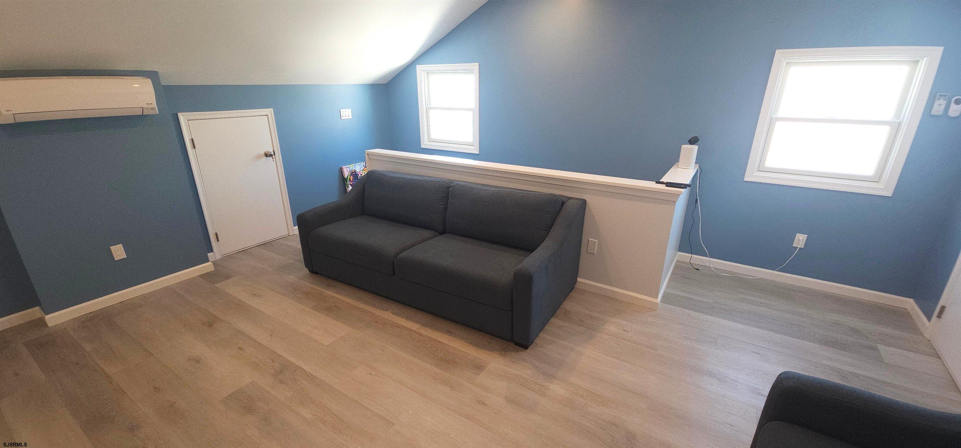 322 38th Street South, Unit B Brigantine, NJ 08203 - Photo 10 of 21 a hallway with a couch and a window
