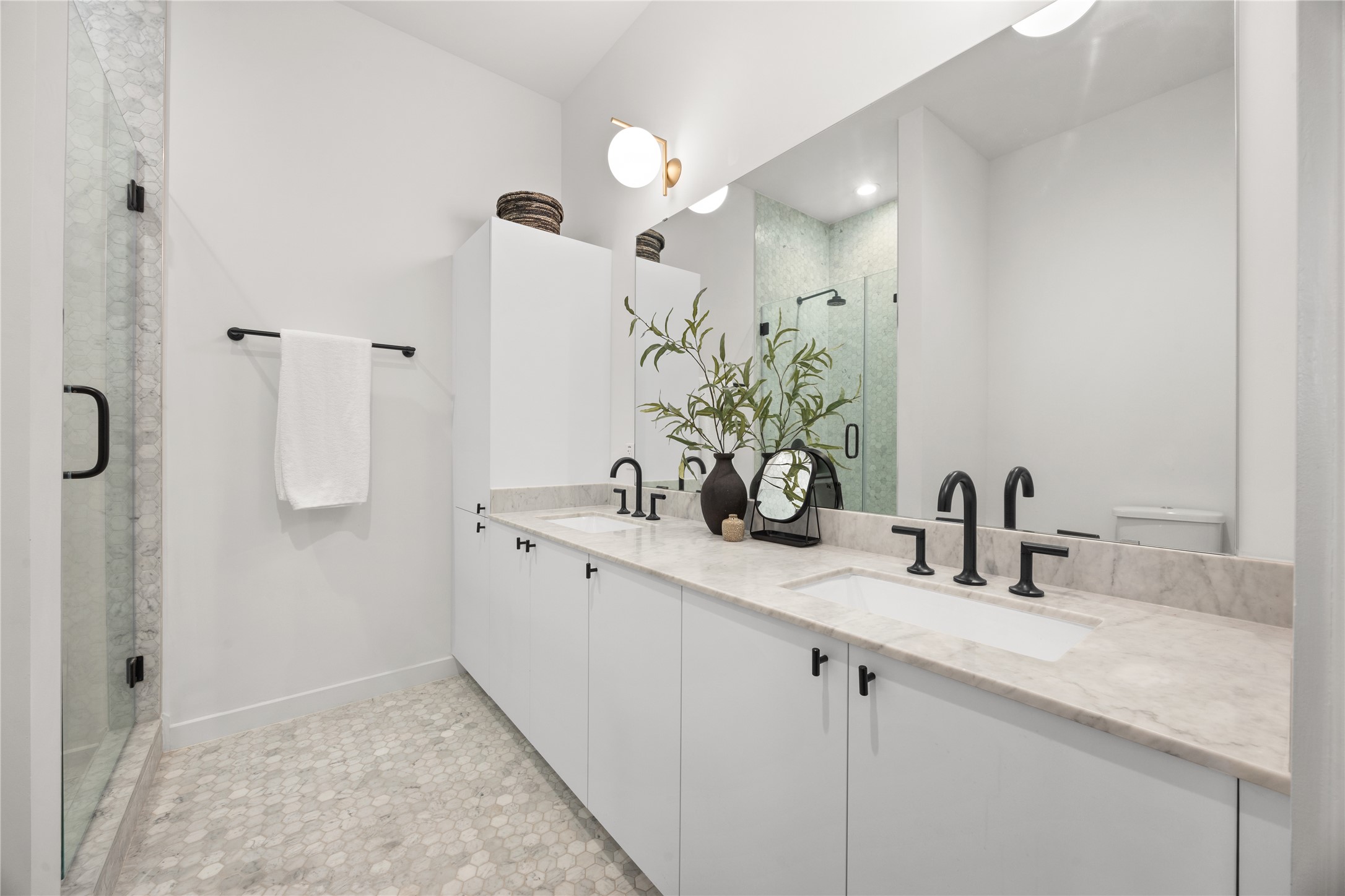 800 Embassy Drive, Unit 602 Austin, TX 78702 - Photo 17 of 37 Contemporary bathroom featuring a double vanity with white cabinetry and stone countertops