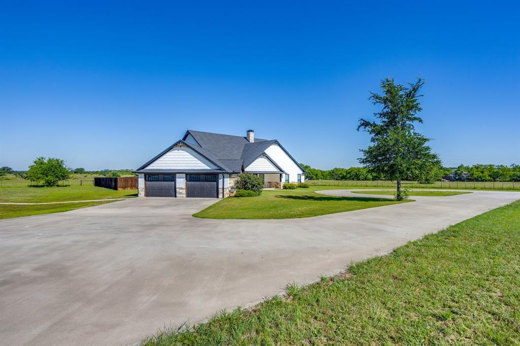 733 Fm 2652 Graham, TX 76450 - Photo 3 of 40 a view of a house with a big yard and potted plants