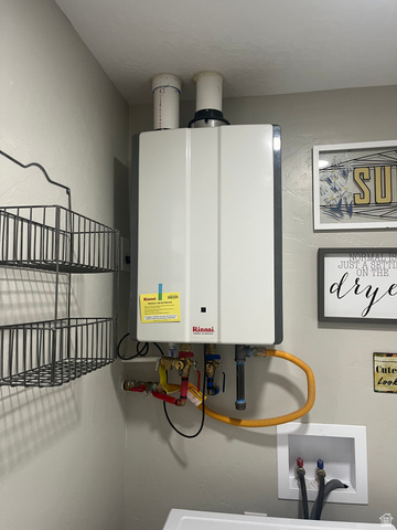 558 North N Cres Road Roosevelt, UT 84066 - Photo 10 of 31 Wall-mounted Rinnai tankless water heater with visible plumbing and venting connections