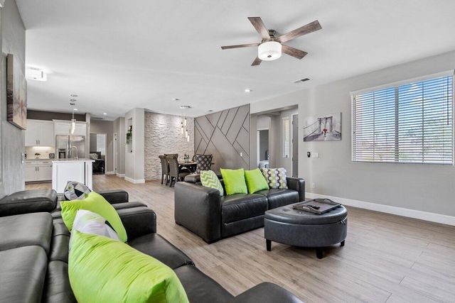 a kitchen with kitchen island granite countertop a sink cabinets and stainless steel appliances