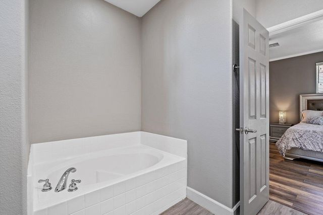 a bedroom with two beds and a flat screen tv