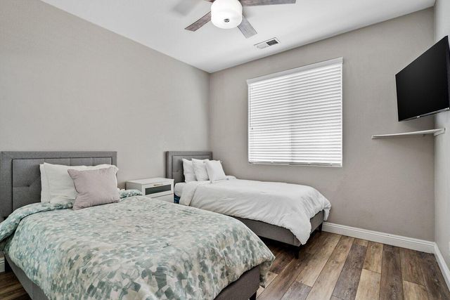 a spacious bedroom with a bed and a chandelier